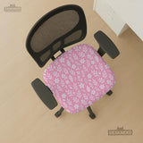 Soft pink floral chair cover shown on a gaming chair with a high back and armrests.