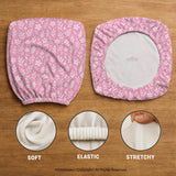 Soft pink floral chair cover shown on a gaming chair with a high back and armrests.