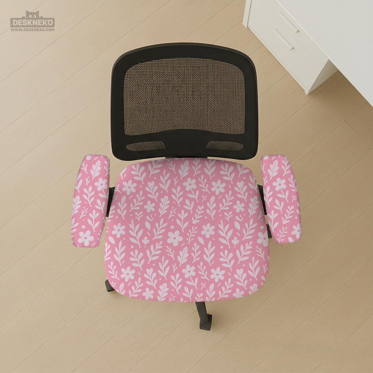 Soft pink floral chair cover shown on a gaming chair with a high back and armrests.