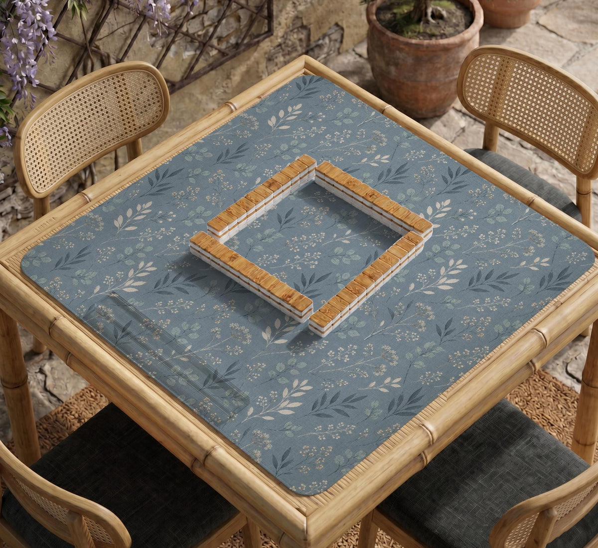 Blue mahjong mat with a dusty linen-look background and small leafy botanical stems in a floral pattern.