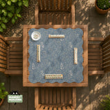 Blue mahjong mat with a botanical floral pattern, pale leaves, and delicate stems on a dusty blue background.