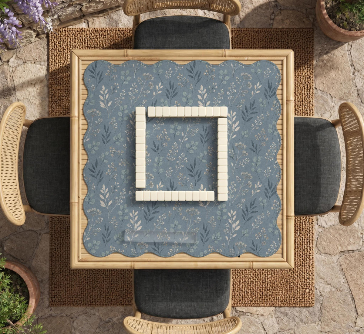 Blue mahjong mat with a dusty linen-look background and small leafy botanical stems in a floral pattern.