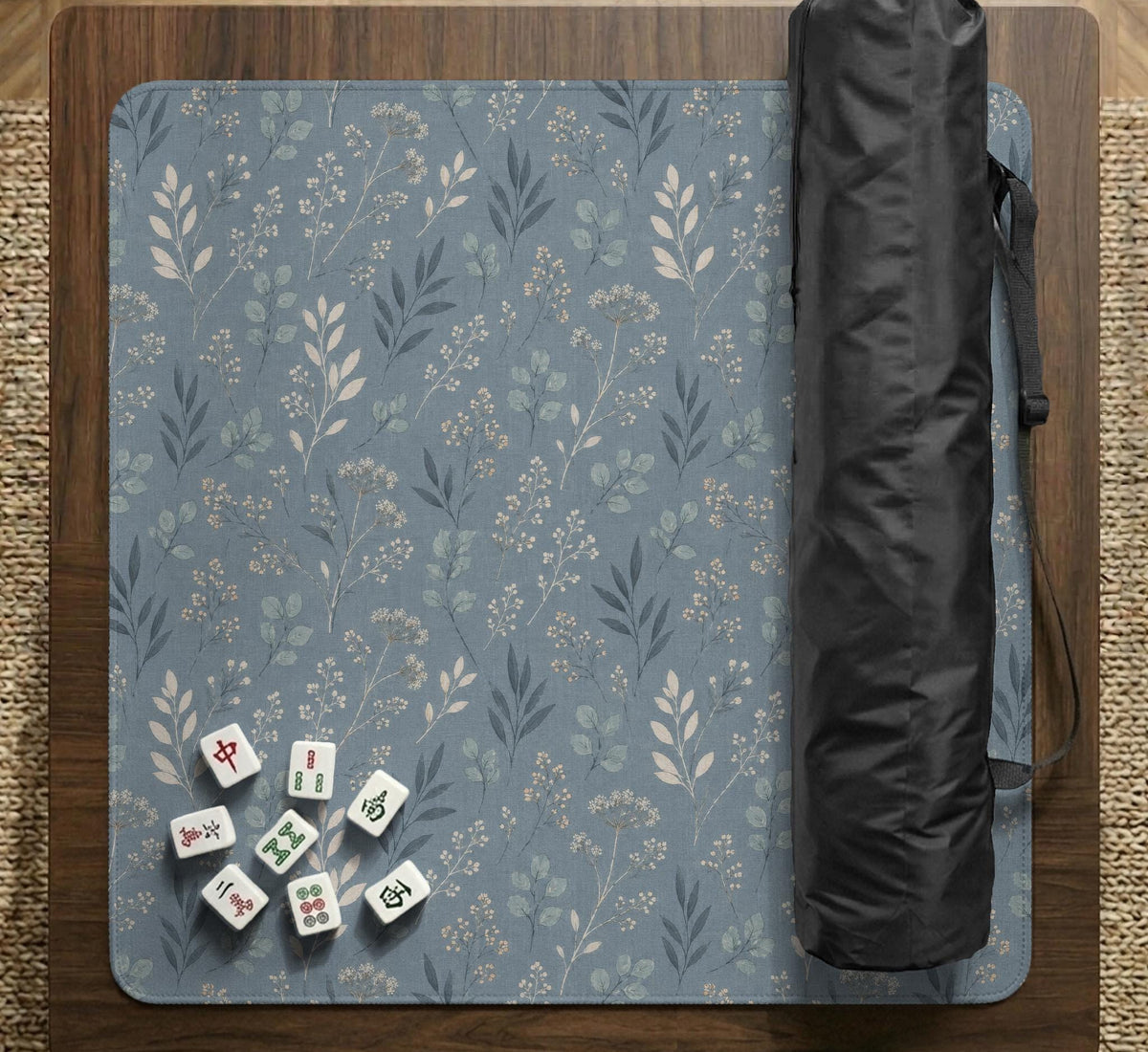 Blue mahjong mat with a dusty linen-look background and small leafy botanical stems in a floral pattern.