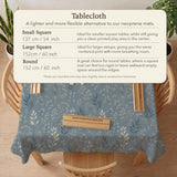 Blue mahjong mat with a dusty linen-look background and small leafy botanical stems in a floral pattern.