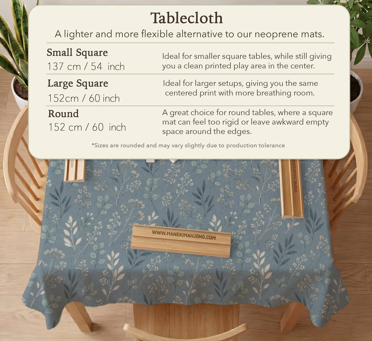 Blue mahjong mat with a botanical floral pattern, pale leaves, and delicate stems on a dusty blue background.