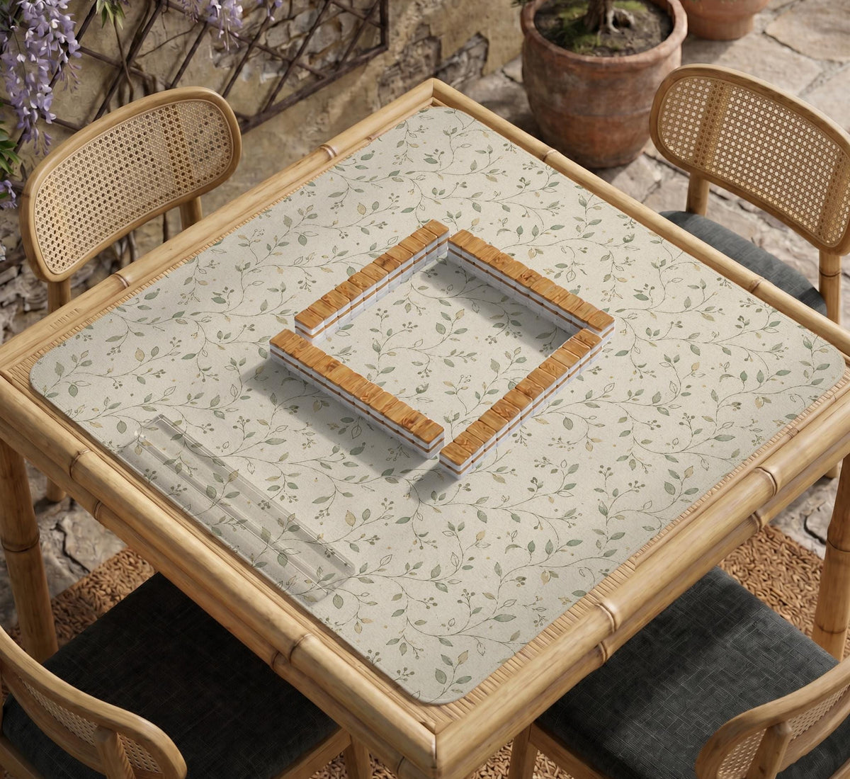 Sage green botanical mahjong mat with a cream background, trailing vines, and muted leaf designs.