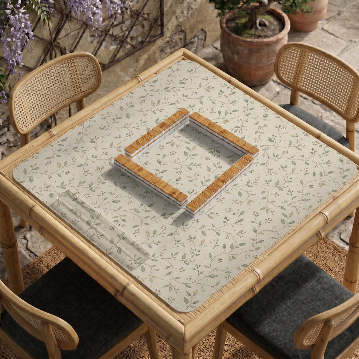 Sage green botanical mahjong mat with a cream background, trailing vines, and muted leaf designs.