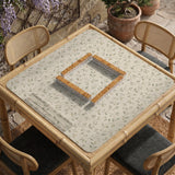 Cream square mahjong mat with a sage vine and leaf botanical pattern and scalloped edges.