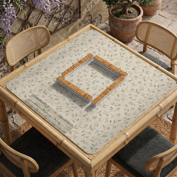 Cream square mahjong mat with a sage vine and leaf botanical pattern and scalloped edges.