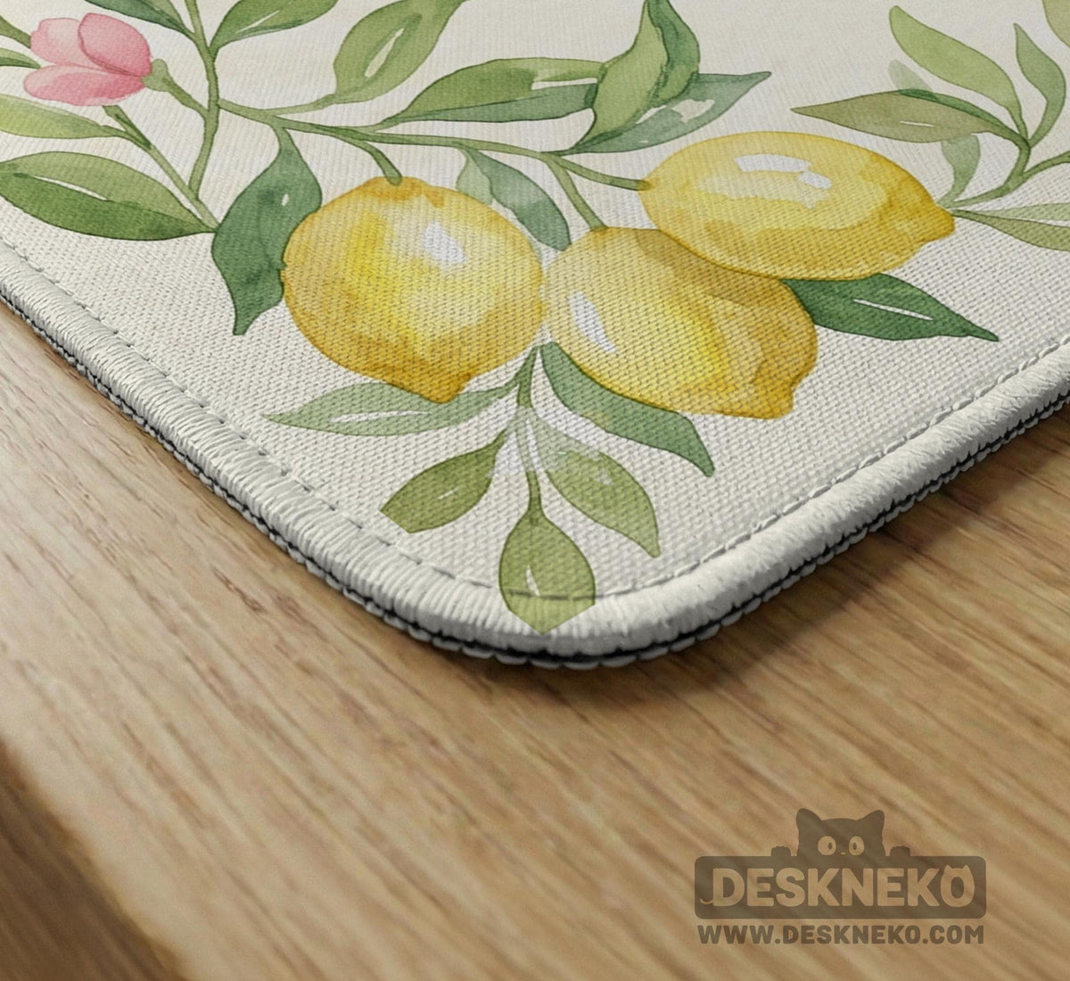 Square yellow mahjong mat with a citrus garden border, green vines, pink blossoms, aqua accents, and a plain center play area.