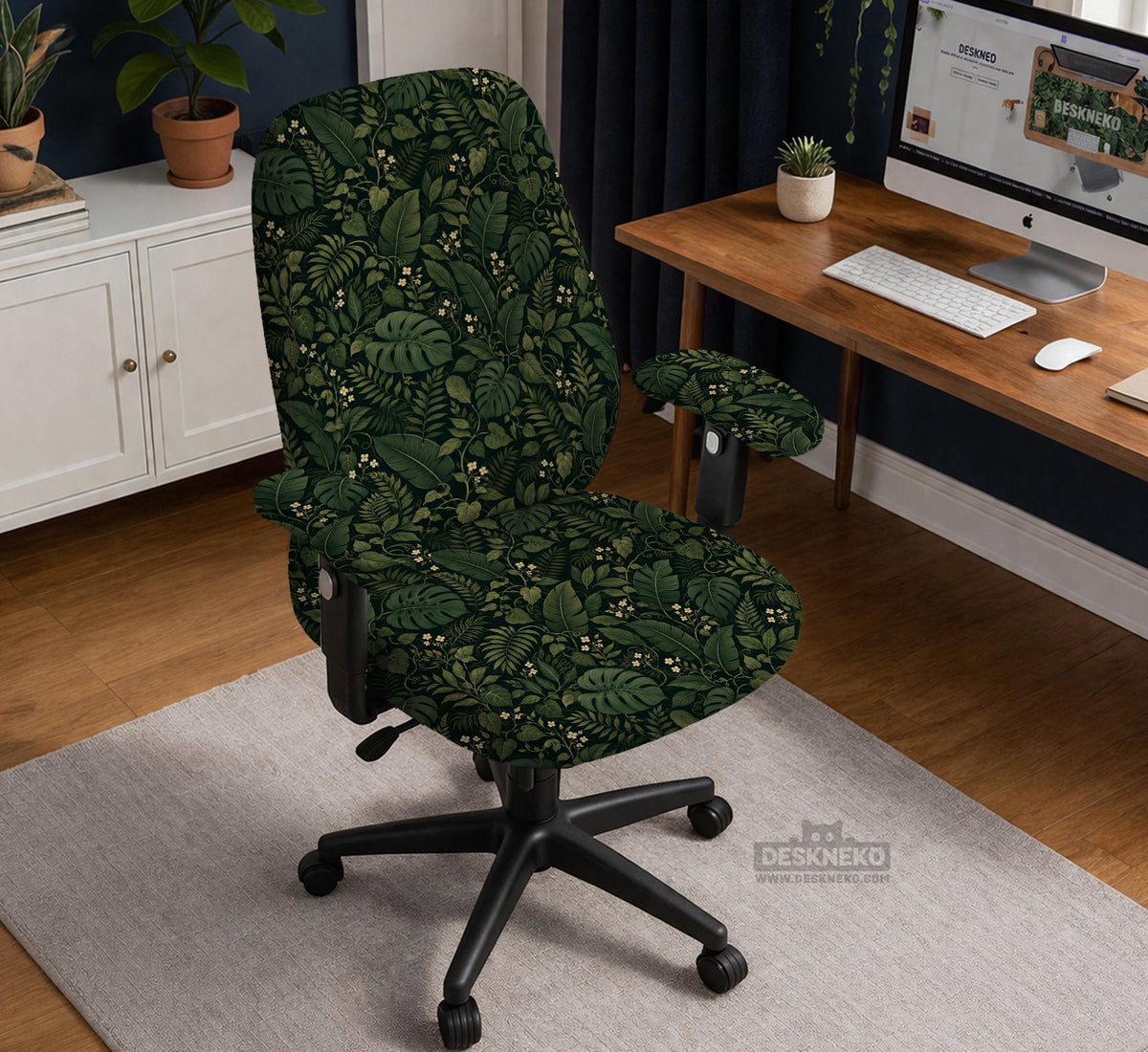 Forest green chair cover with a tropical leaf pattern featuring monstera leaves and small cream flowers.