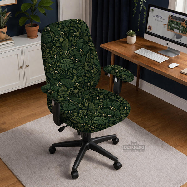 Forest green chair cover with a tropical leaf pattern featuring monstera leaves and small cream flowers.