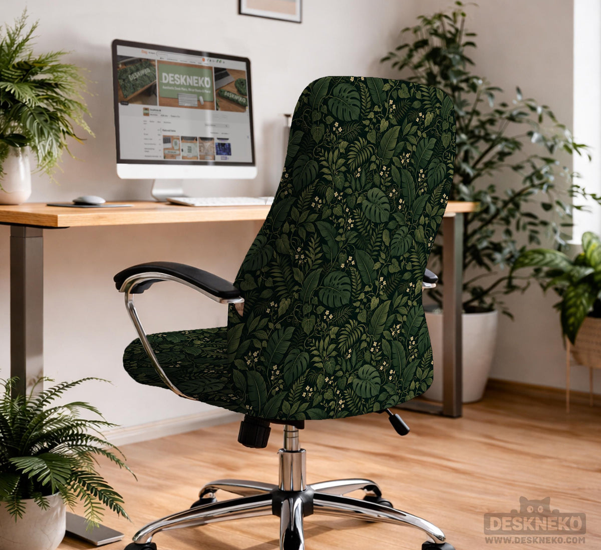 Forest green chair cover with a tropical leaf pattern featuring monstera leaves and small cream flowers.
