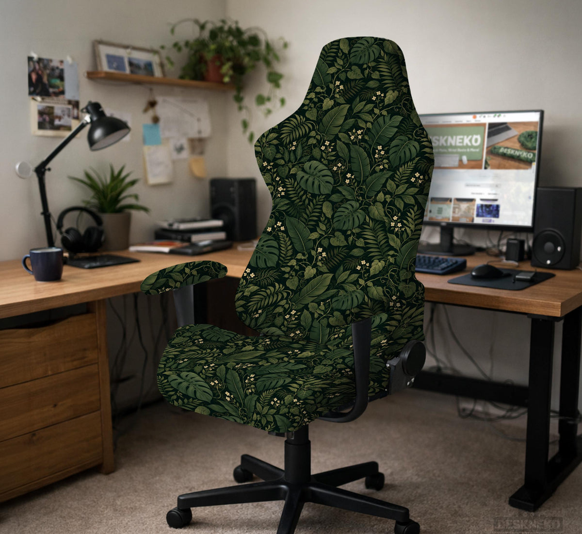 Forest green chair cover with a tropical leaf pattern featuring monstera leaves and small cream flowers.
