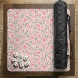 Pink mahjong mat with a tulip floral pattern in blush and sage tones and a scalloped edge.