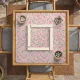 A pink mahjong mat with tulip flowers, sage leaves, and a light pastel background.