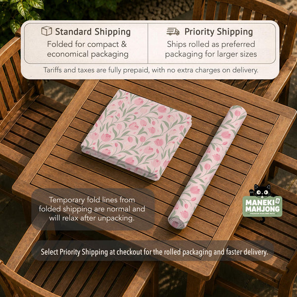 Pink mahjong mat with a tulip floral pattern in blush and sage tones and a scalloped edge.