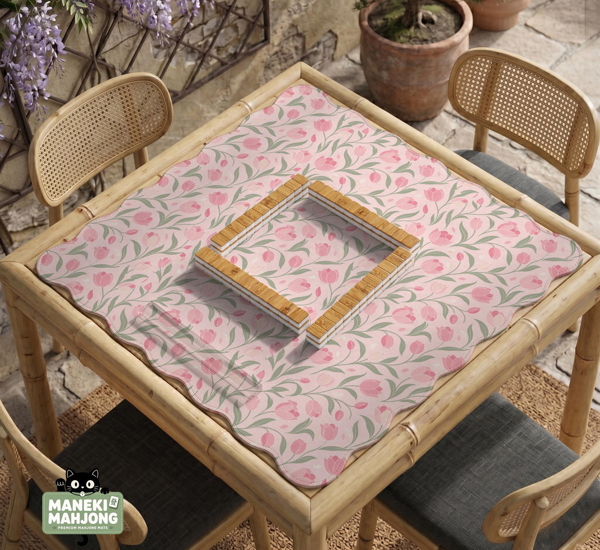 Pink mahjong mat with a tulip floral pattern in blush and sage tones and a scalloped edge.
