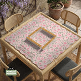 A pink mahjong mat with tulip flowers, sage leaves, and a light pastel background.