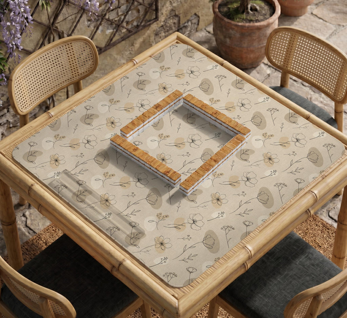 Neutral floral mahjong mat with delicate botanical line art and a scalloped edge on a cream background.