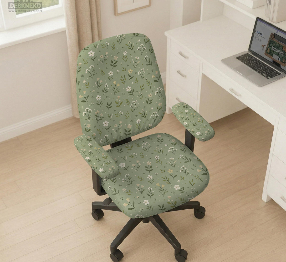 Sage green chair cover with a small floral print shown on a desk chair with a high back.