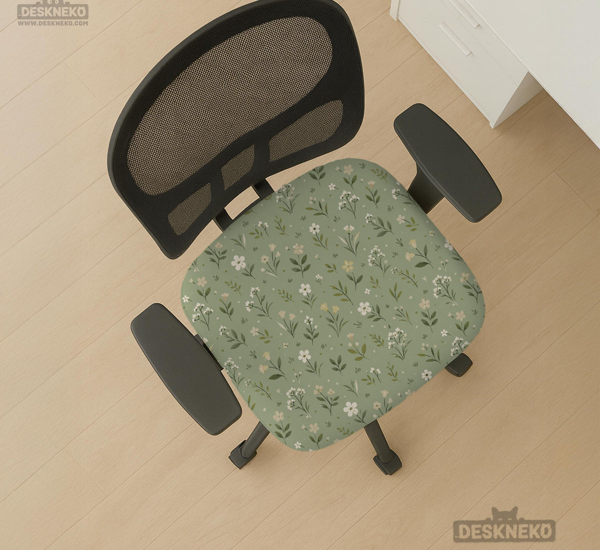 Sage green chair cover with a small floral print shown on a desk chair with a high back.
