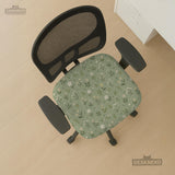Sage green chair cover with a small floral print shown on a desk chair with a high back.