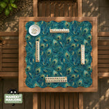 Teal mahjong mat with a peacock feather pattern in blue green tones.
