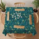 A teal mahjong mat with a peacock feather pattern and scalloped edges.