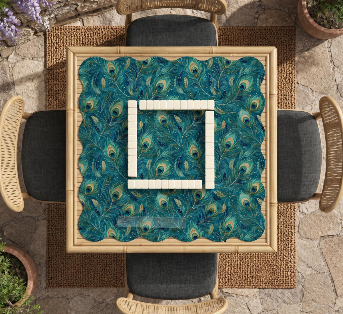 A teal mahjong mat with a peacock feather pattern and scalloped edges.