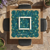 A teal mahjong mat with a peacock feather pattern and scalloped edges.