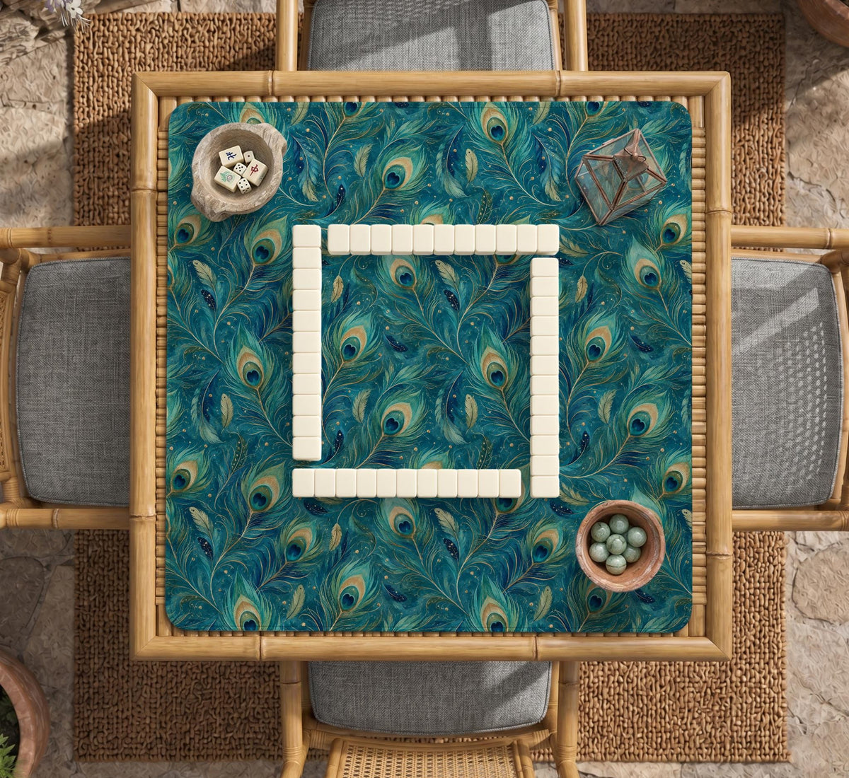 A teal mahjong mat with a peacock feather pattern and scalloped edges.