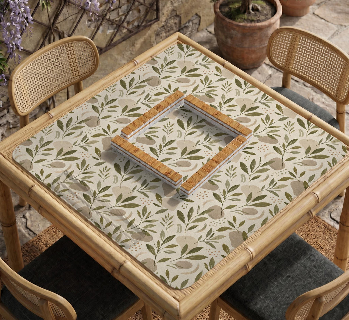 Green botanical mahjong mat with sage leaf and floral design and a scalloped edge.