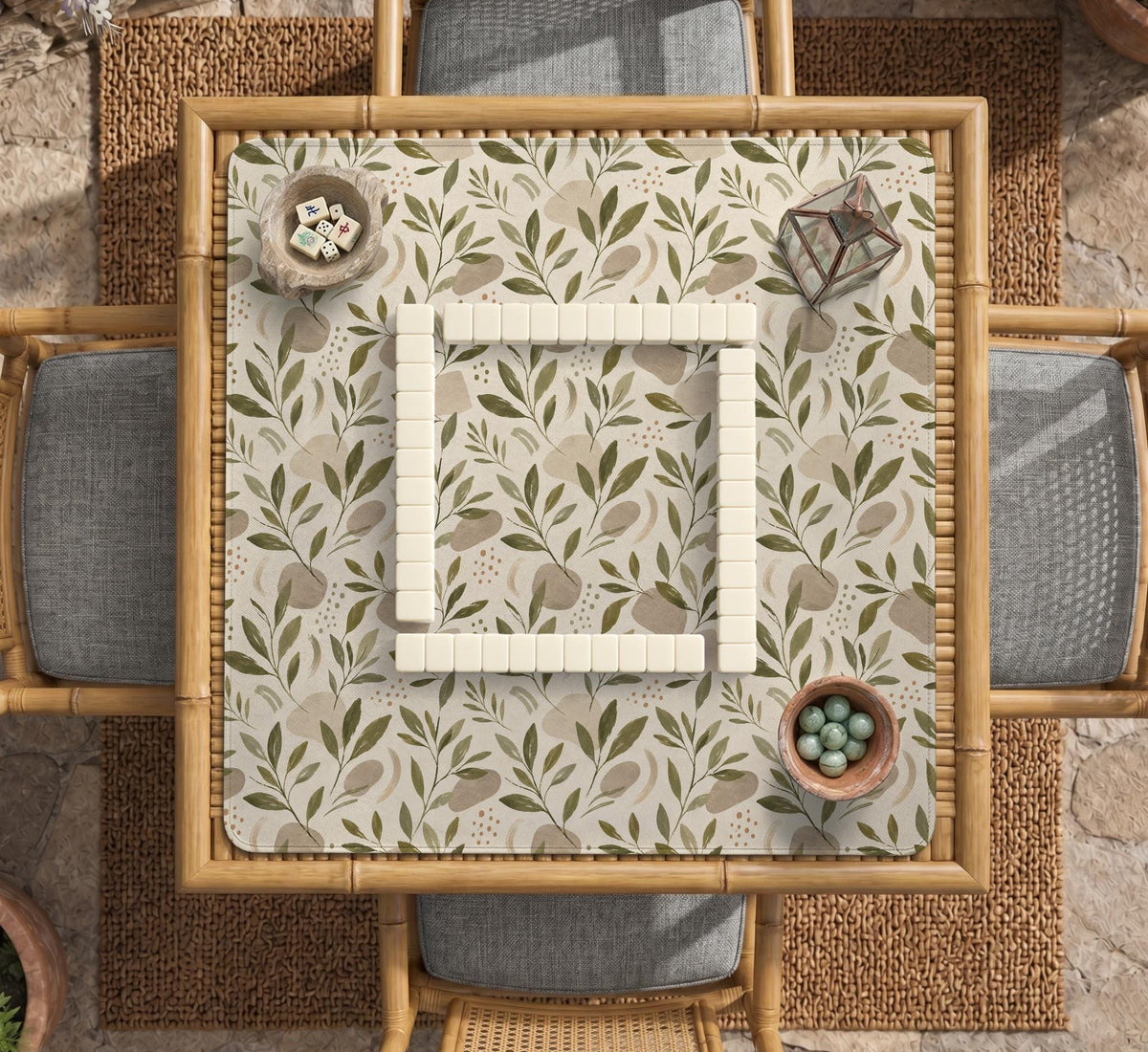 Green botanical mahjong mat with sage leaf and floral design and a scalloped edge.