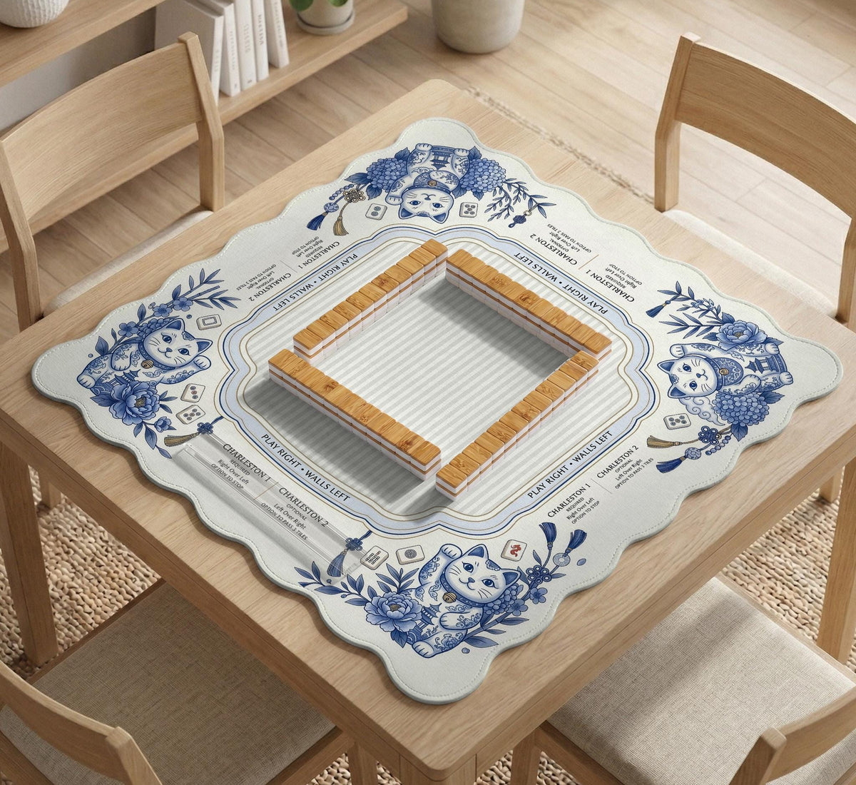 Blue and white square mahjong mat with lucky cat artwork, floral chinoiserie pattern, tile icons, and a rule guide layout.