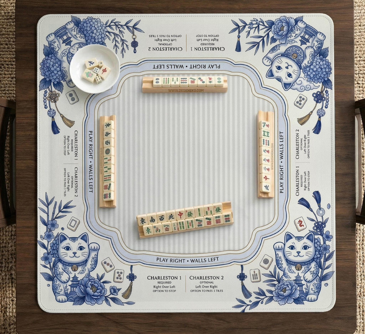Blue and white square mahjong mat with lucky cat artwork, floral chinoiserie pattern, tile icons, and a rule guide layout.