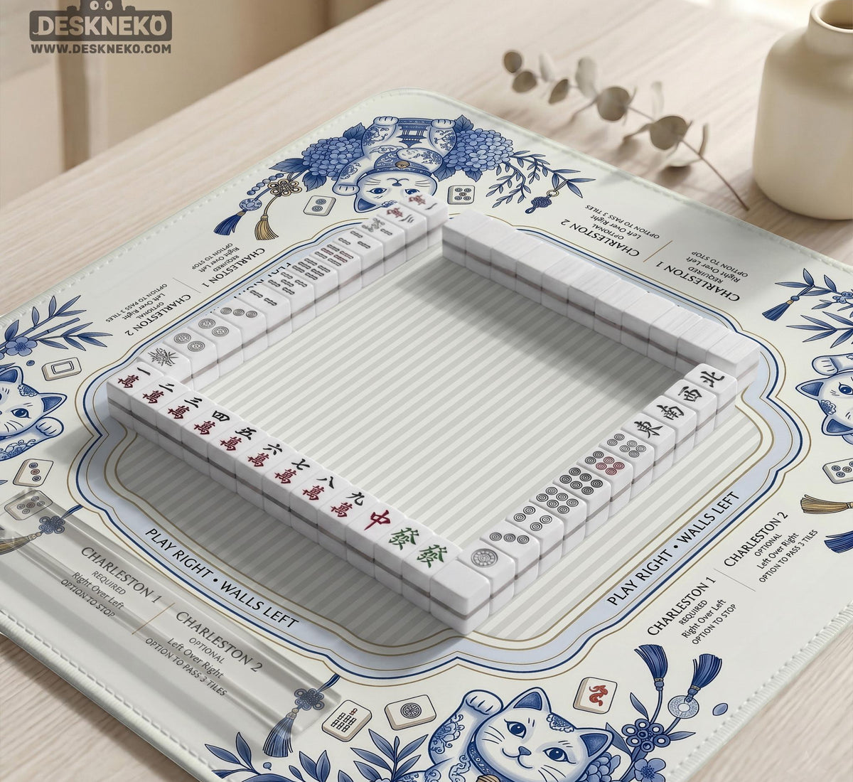 Blue and white square mahjong mat with lucky cat artwork, floral chinoiserie pattern, tile icons, and a rule guide layout.