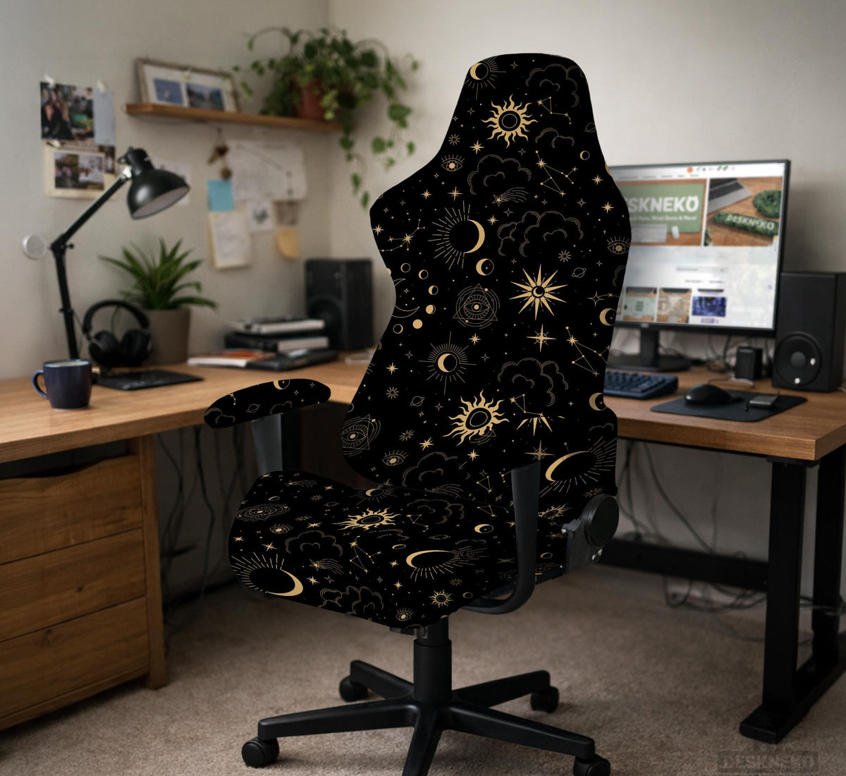 Black chair cover with gold moons, suns, stars, constellations, and line art printed across the fabric.