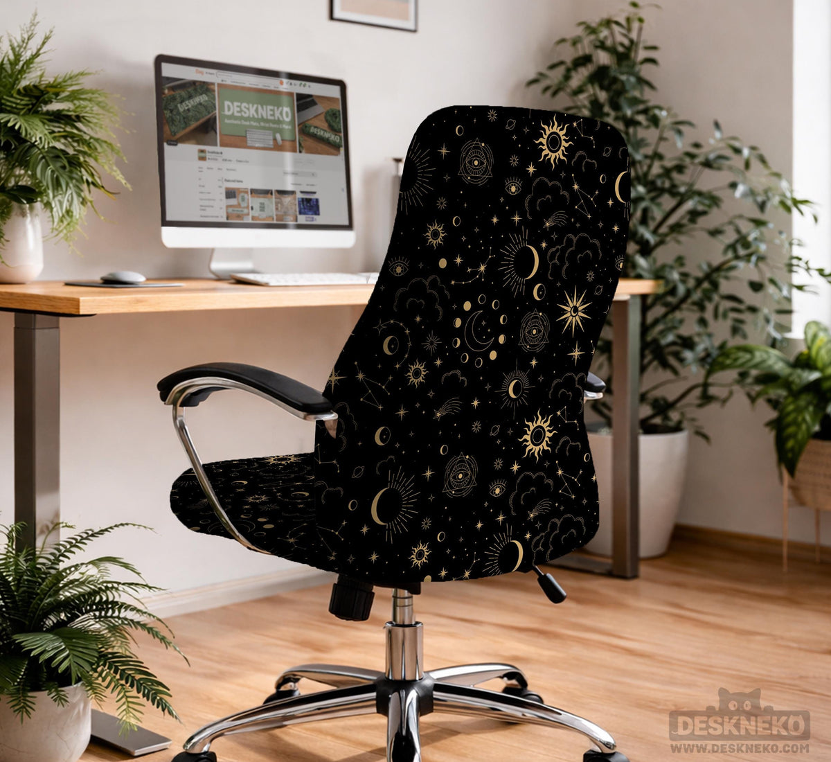 Black chair cover with gold moons, suns, stars, constellations, and line art printed across the fabric.