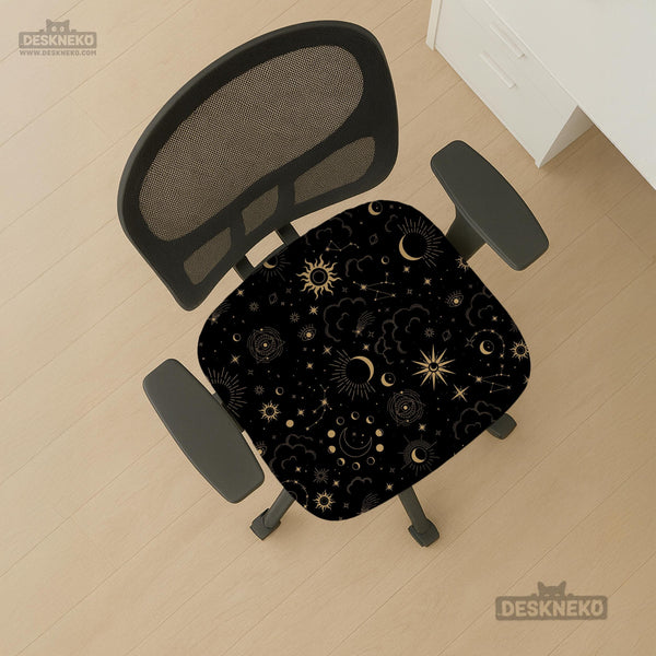 Black chair cover with a gold astrology print of moons, suns, stars, and symbols on a gaming chair.