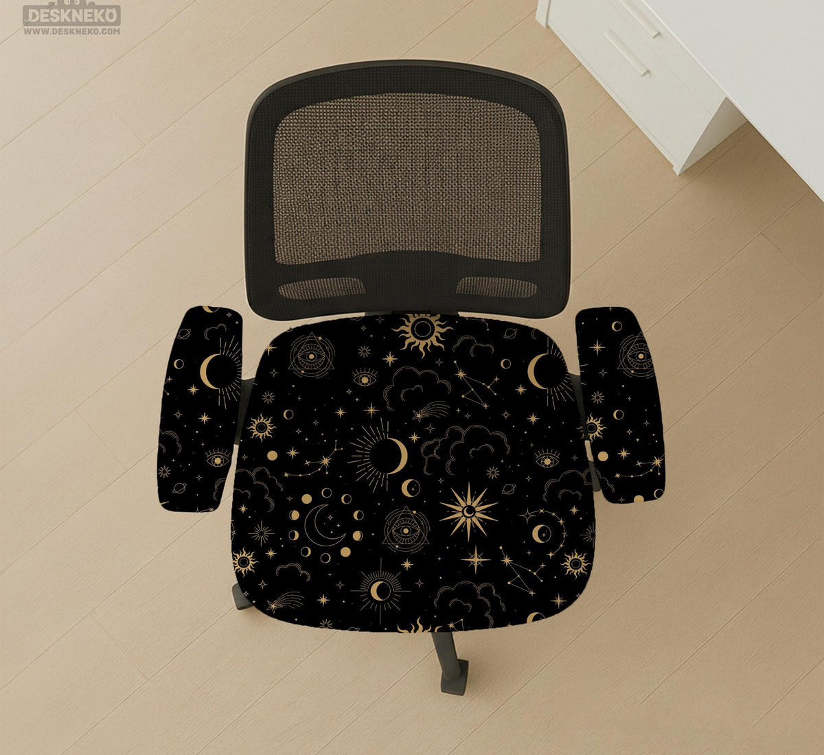 Black chair cover with gold moons, suns, stars, constellations, and line art printed across the fabric.