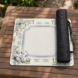 Beige square mahjong mat with a sage border, crane birds, bamboo, flowers, tile icons, and printed rules around a clean center play area.