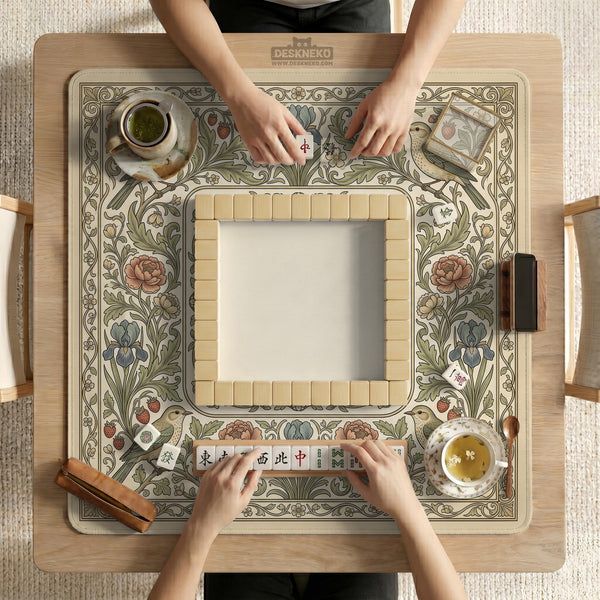 Square mahjong table mat with vintage bird artwork, floral border detail, and sage green, cream, muted blue, and terracotta tones.