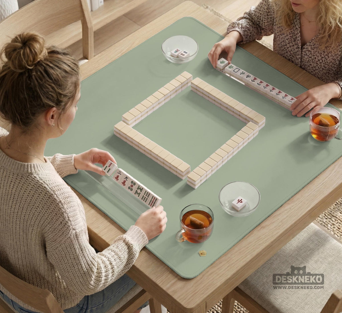 A plain light sage green square mahjong mat with a smooth solid-color surface.