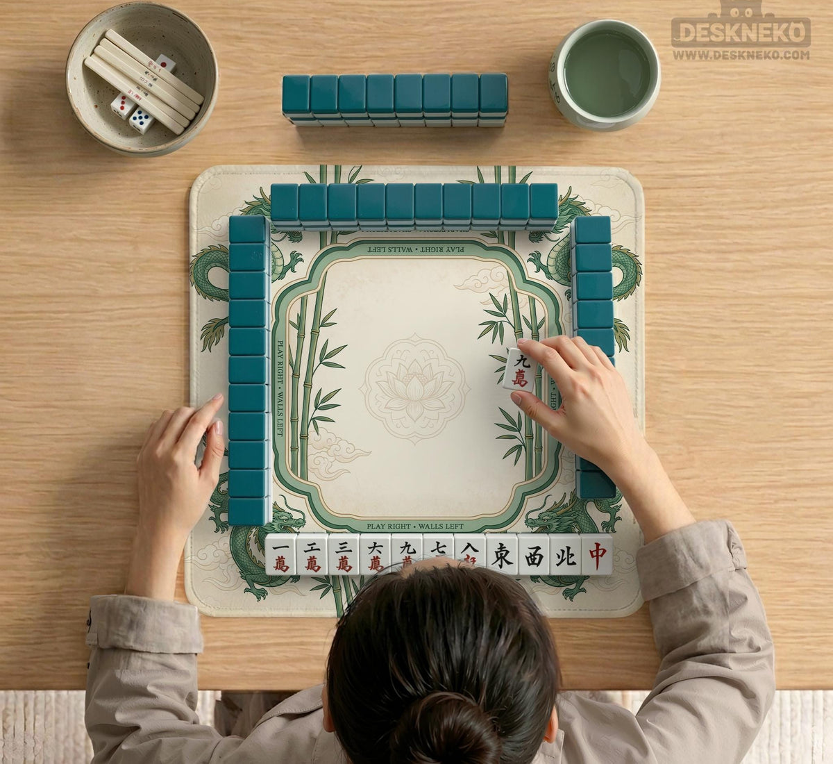 Sage green mahjong mat with a bamboo pattern, dragon design, printed rules around the edge, and a scalloped edge option.