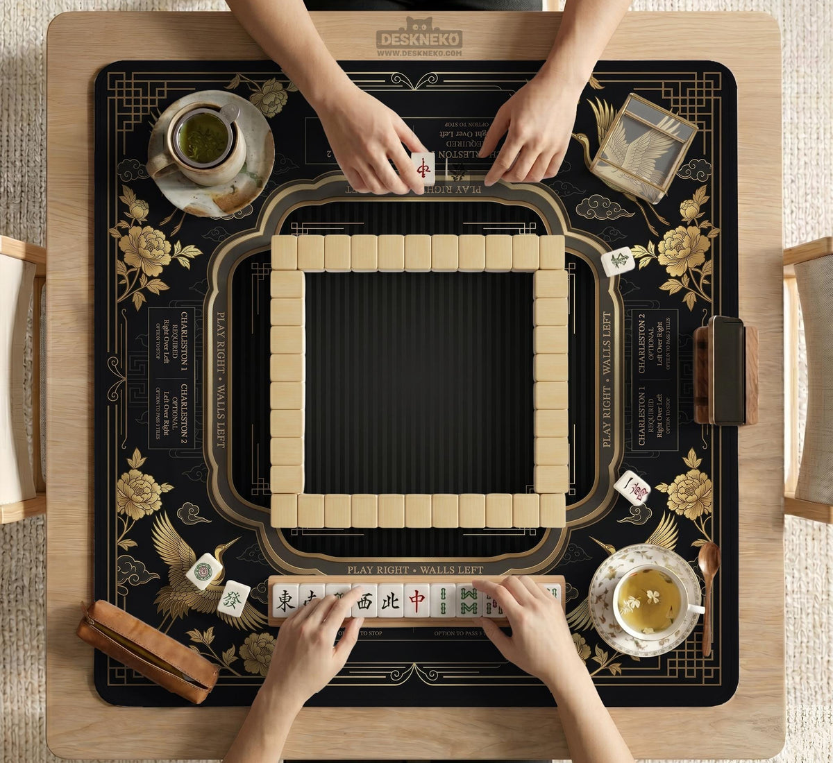 Black and gold square mahjong mat with an art deco crane and floral border, rule reminders around the edges, and a blank center area.