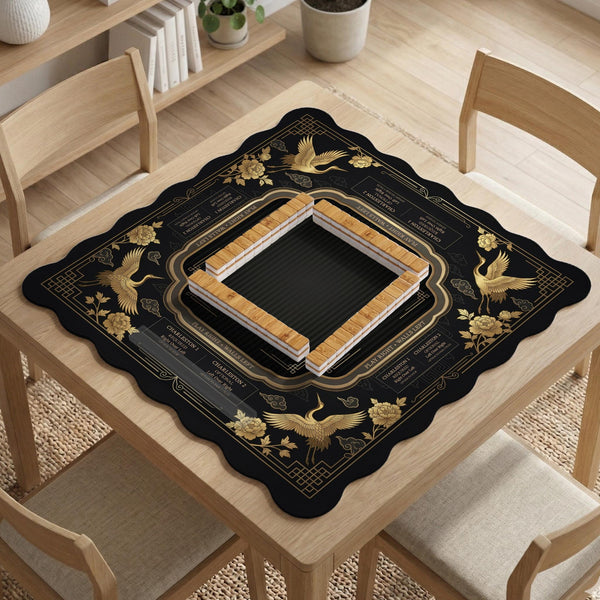 Black and gold square mahjong mat with an art deco crane and floral border, rule reminders around the edges, and a blank center area.