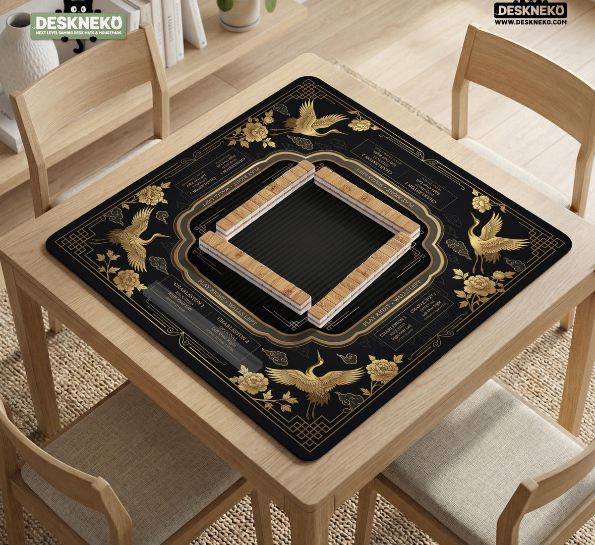 Black and gold square mahjong mat with an art deco crane and floral border, rule reminders around the edges, and a blank center area.