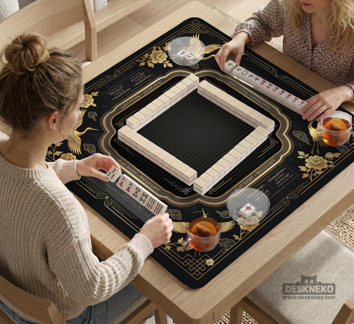 Black and gold square mahjong mat with an art deco crane and floral border, rule reminders around the edges, and a blank center area.