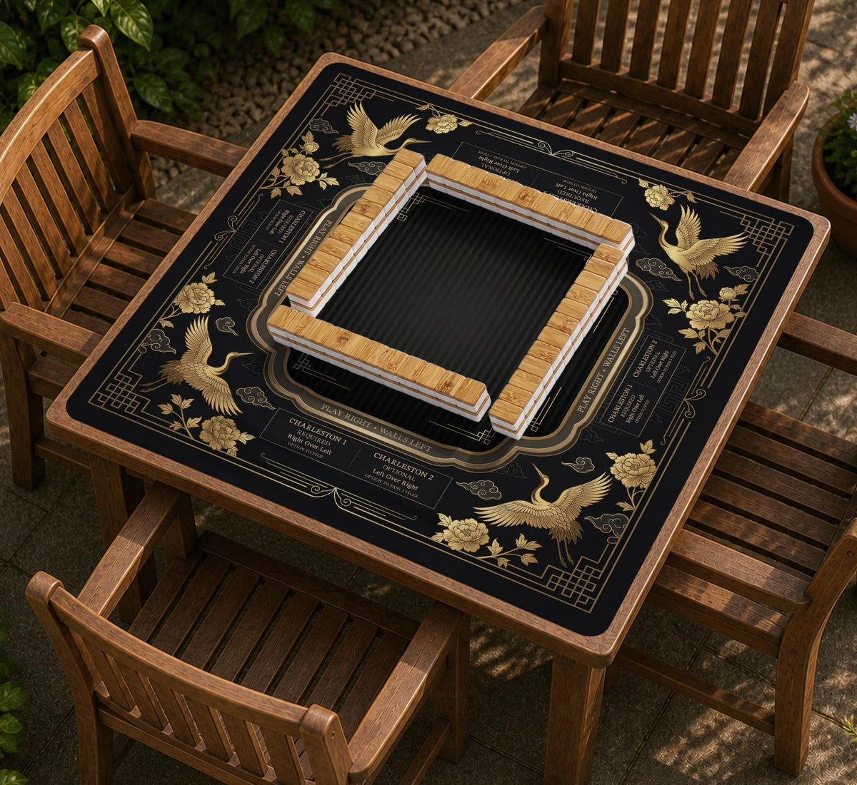 Black and gold square mahjong mat with an art deco crane and floral border, rule reminders around the edges, and a blank center area.